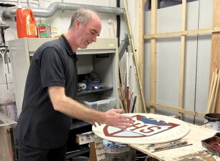 Roger looking at design in workshop.