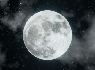 The full moon with clouds scudding across the sky