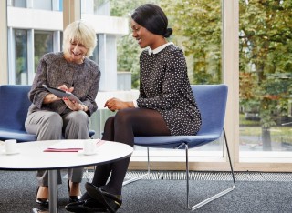 Two women looking at tablet