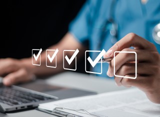 Person clicking virtual tick boxes on screen