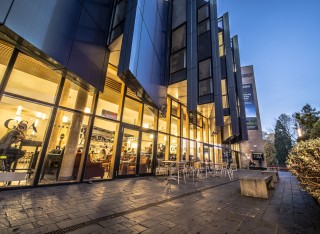 Exterior of the Guildford School of Acting building at dusk
