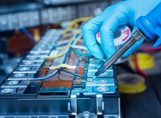 Technician soldering lithium-ion battery 