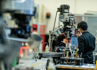 Student works on machines in engineering workshop
