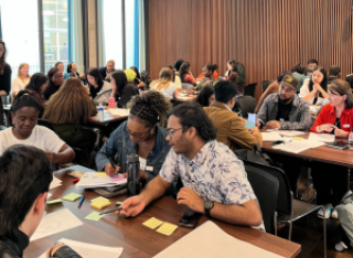 Students sitting around tables discussing