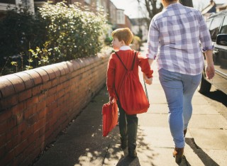 mother and son walking to school