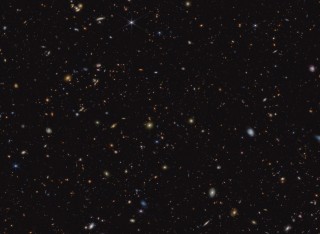 The image shows a deep galaxy field, featuring thousands of galaxies of various shapes and sizes.