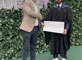 Surrey Business School student, Najam, receiving award from chair of Chartered Accountants South East Society, that recognises the highest grades in the University of Surrey's final year Institute of Chartered Accountants in England and Wales (ICAEW) accredited modules