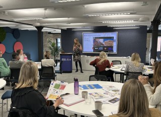 Photo of Emily giving a speech the White Rose Education Maths team