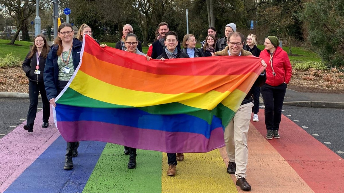 Surrey community on campus with rainbow flag