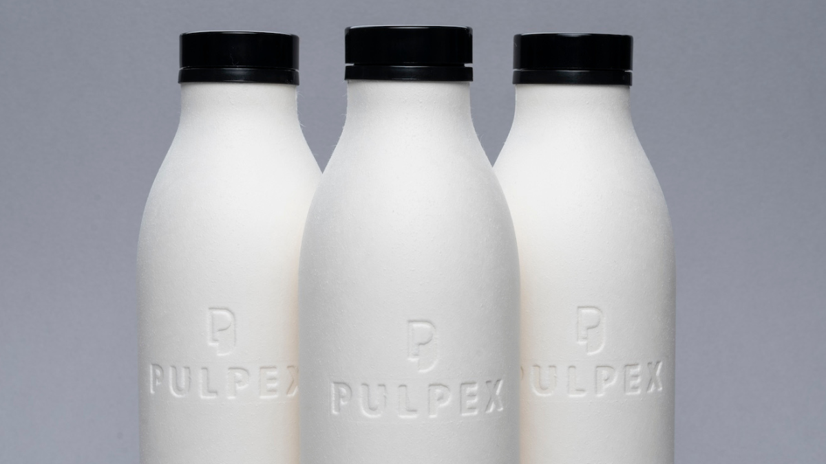 Three Pulpex paper fibre bottles displayed on a grey background