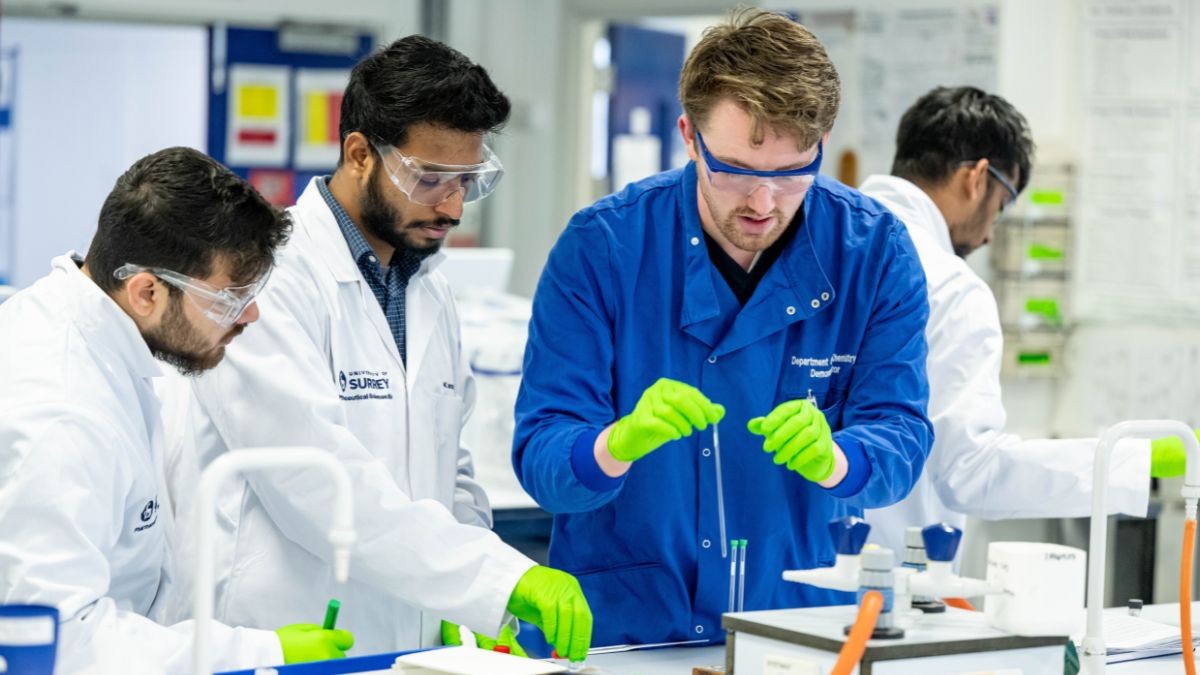 Pharmaceutical Sciences students at work in the lab with a technician