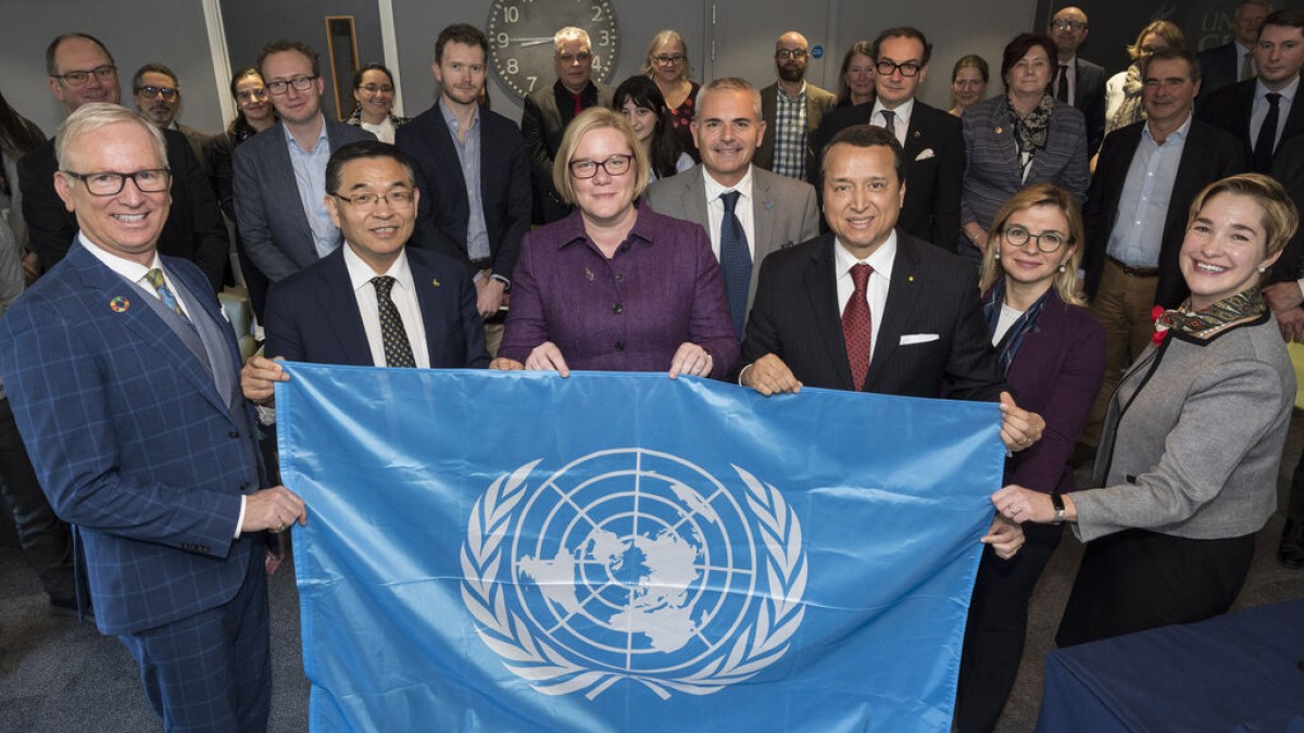 CIFAL Surrey event lots of people holding a flag