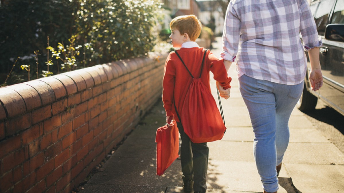 mother and son walking to school
