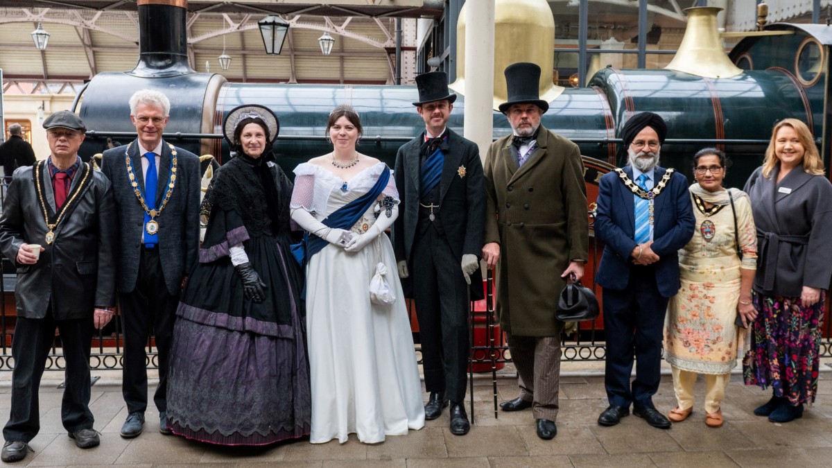 Dignatories and people in Victorian dress at Windsor Station