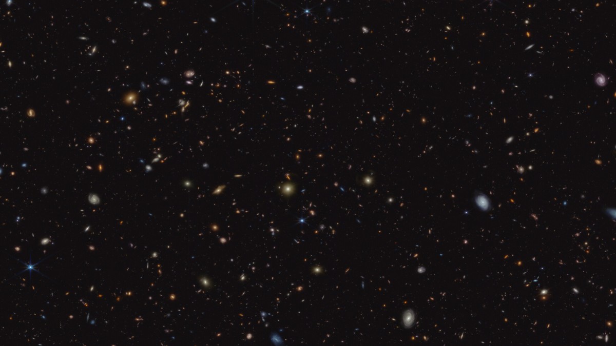 The image shows a deep galaxy field, featuring thousands of galaxies of various shapes and sizes.