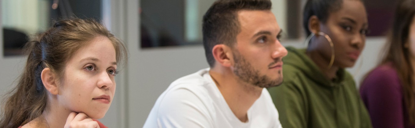 a row of attentive students in class